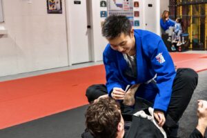 Teen practising Brazilian Jiu-Jitsu with an adult coach in Calgary
