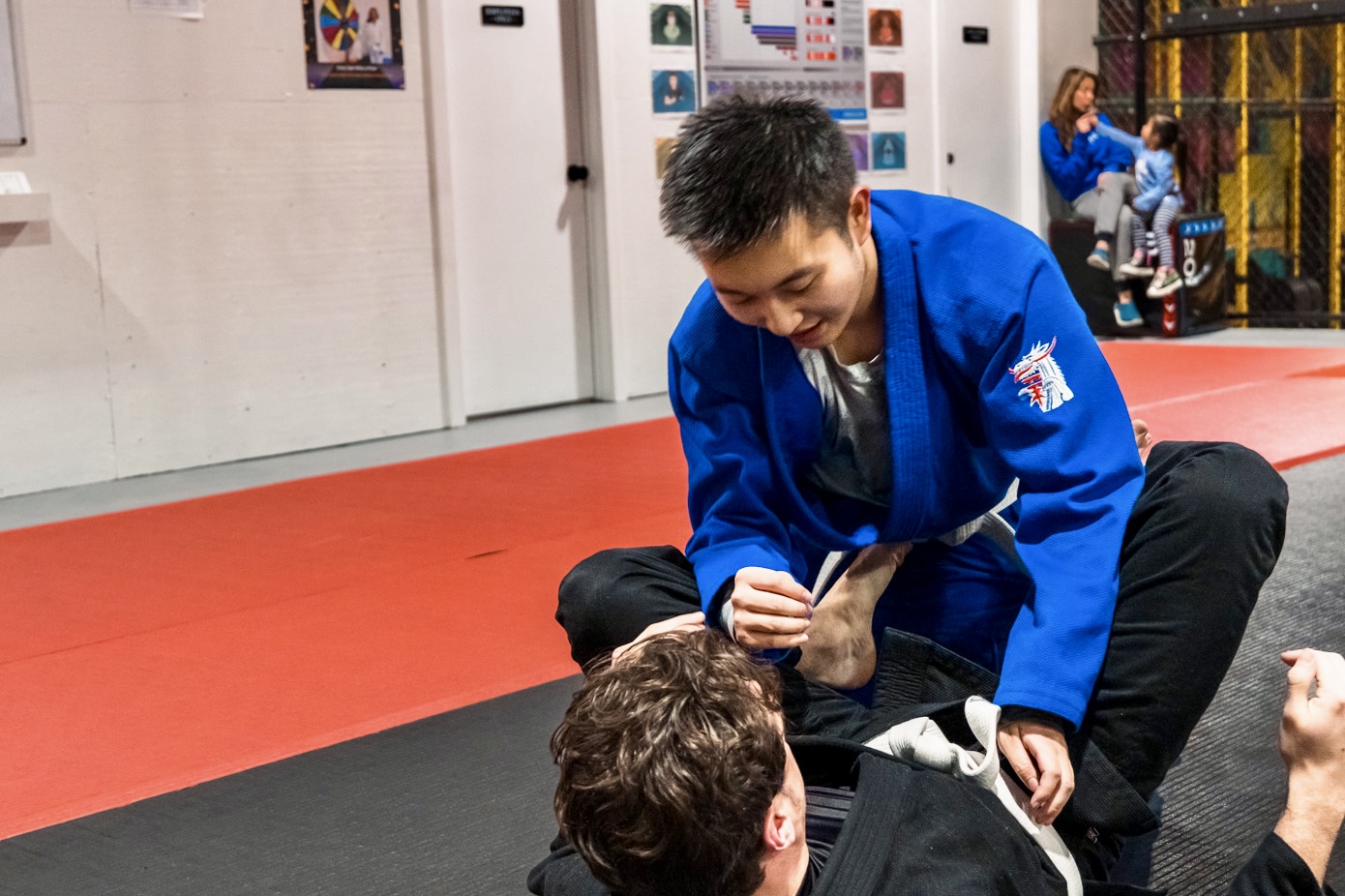 Teen practising Brazilian Jiu-Jitsu with an adult coach in Calgary